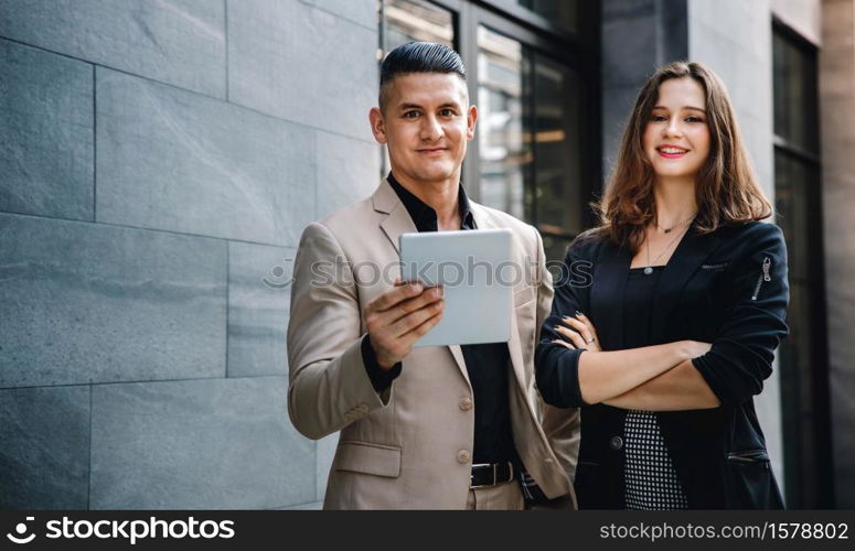 Teamwork or Work Together Concept. Portrait of Businessman and Business Woman Working on Tablet outside the Office