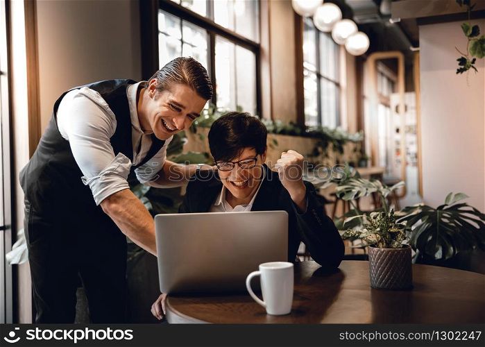 Teamwork or Working Together Concept. Two Businessman Working on Laptop in Creative Working Space. Work Partner Glad for Project Success