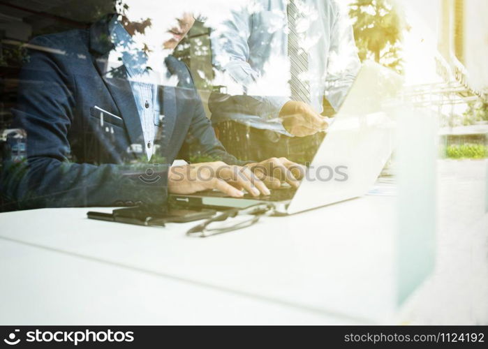 Teamwork process, Image of two young businessmen using laptop at meeting.