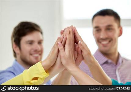 teamwork, success and friendship concept - close up of happy smiling students making high five. happy smiling students making high five