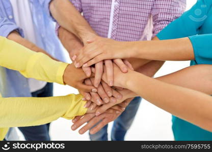 teamwork, unity and friendship concept - close up of group of students stacking hands. group of students stacking hands