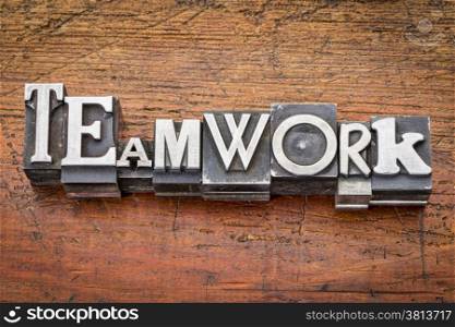 teamwork word in vintage metal type printing blocks over grunge wood