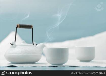 Teapot and cups on table at comfortable relaxation lounge