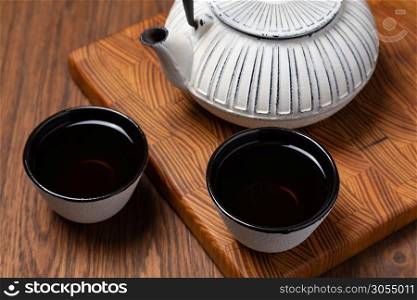 Teapot and Teacups on wooden background. Chinese Teapot