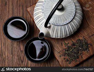 Teapot and Teacups on wooden background. Chinese Teapot