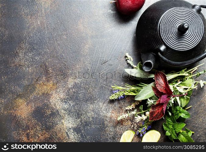teapot with aroma herb for tea on a table