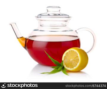 Teapot with black tea, green leaves and lemon slices isolated on white background