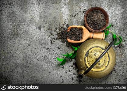 Teapot with fragrant tea. On a rustic background.. Teapot with fragrant tea.
