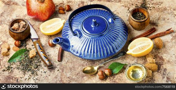 Teapot with lemon tea.Natural ingredients for tea.Porcelain blue teapot. Tea with lemon