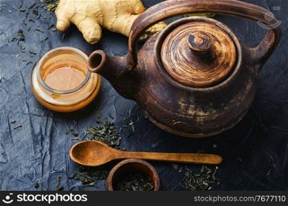 Teapot with tea made from ginger,honey and lemon.Vitamin, healing tea. Ginger root tea