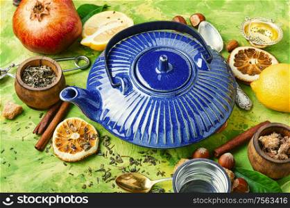 Teapot with tea.Natural ingredients for tea.Porcelain blue teapot.Useful tea with lemon.. Tea with lemon