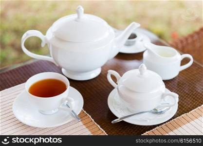 teatime, drink and object concept - close up of tea service on table at restaurant or teahouse