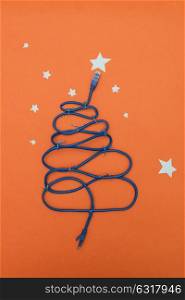Tech New Year: fir-tree from wires on orange background. Tech New Year: