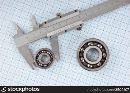 Technical drawing and callipers with bearing on graph paper