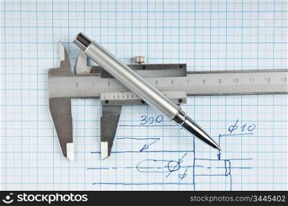 Technical drawing and callipers with pen on graph paper
