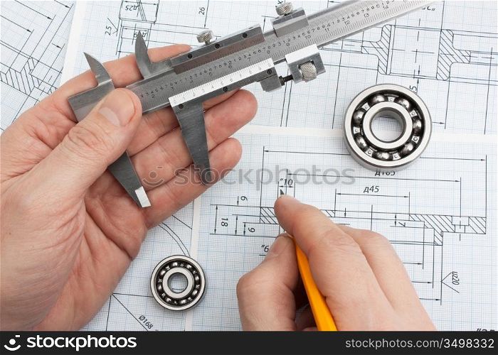 technical drawing and tools in hand