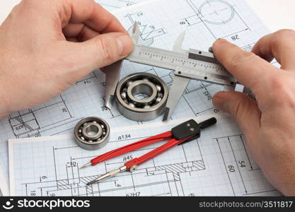 technical drawing and tools in hand