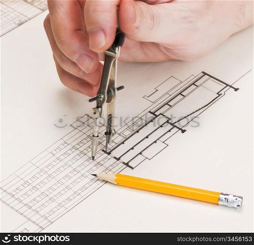 technical drawings and hand with a pencil