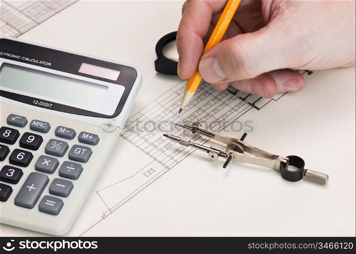 technical drawings and hand with a pencil