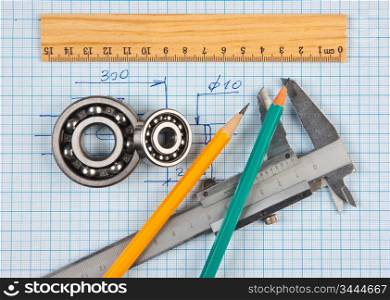 technical tools on a background of graph paper