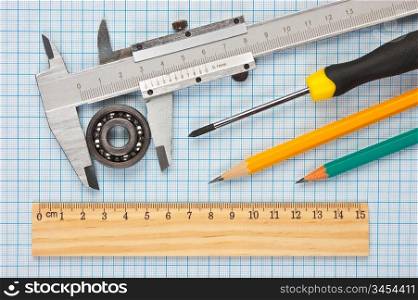 technical tools on a background of graph paper