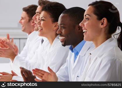 Technician And Colleagues In Laboratory Clapping