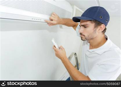 technician checking ac installation in clients building