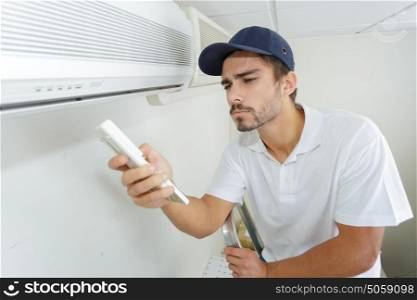 technician checking ac installation in clients building