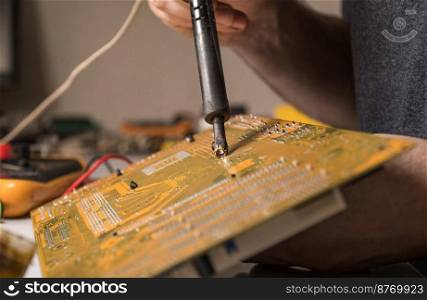 technician electronic soldering and repairing computer chip. master repairs chip