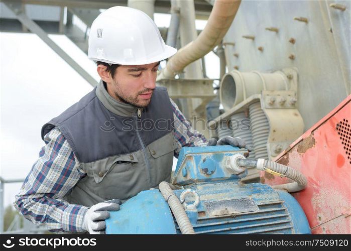 technician inspecting the factory generator