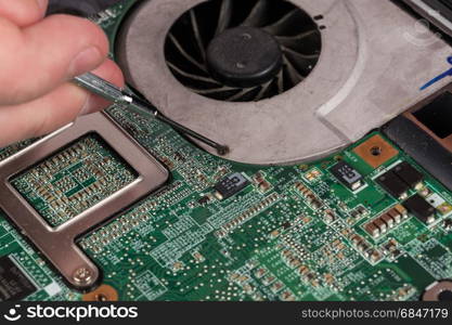 Technician Repairing Laptop At Desk. Close-up Of Technician Repairing Laptop At Desk