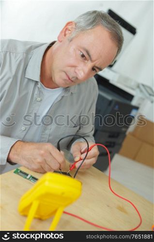 Technician using multimeter