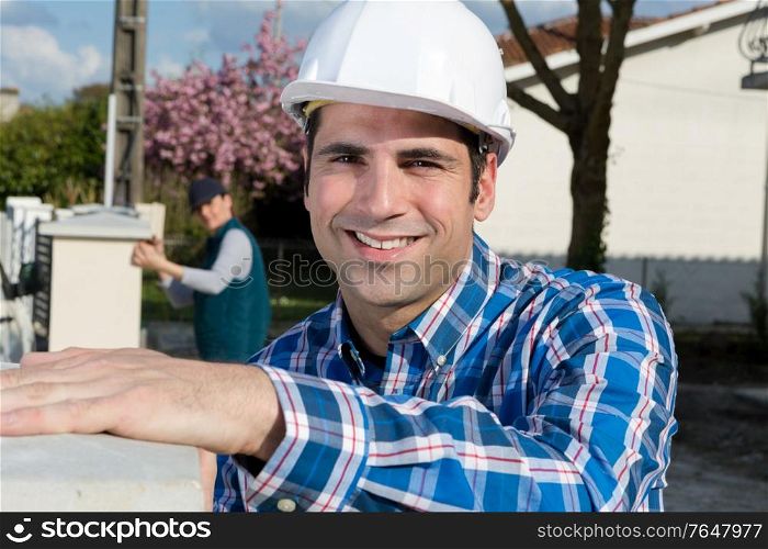technician with helmet standing outdoors