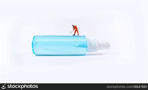 Technician worker figure standing on a alcohol spray bottle. Covid-19 concept.