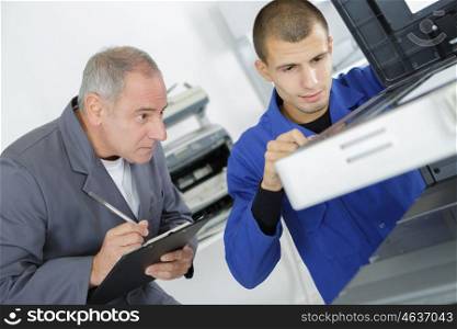 Technicians inspecting appliance