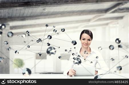 Technologies for work and connection. Attractive elegant woman at table in modern interior. Mixed media