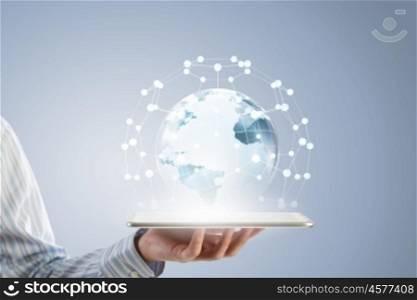 Technologies that conncet the world. Businessman holding in hand tablet with global connection concept