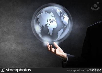 Technologies that connect the world. Hand of businessman showing digital earth globe