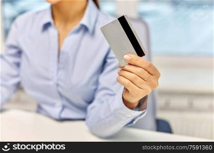 technology, age and people concept - close up of businesswoman with credit card at office. businesswoman with credit card at office