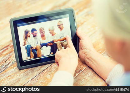 technology, age, memories and people concept - happy senior woman with tablet pc computer viewing family photo album at home