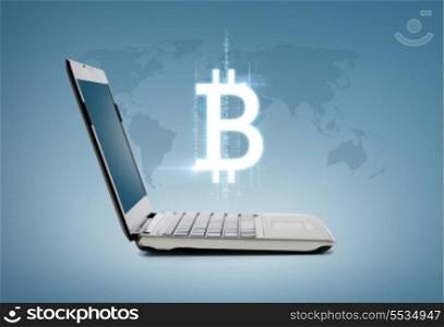 technology and advertisement concept - laptop computer with bitcoin