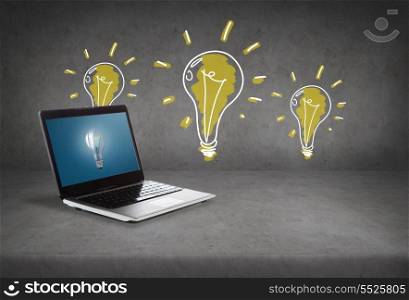 technology and advertisement concept - laptop computer with light bulb on screen