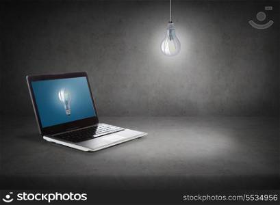 technology and advertisement concept - laptop computer with light bulb on screen
