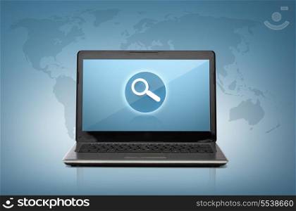technology and advertisement concept - laptop computer with magnifying glass on screen