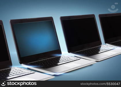 technology and advertisement concept - many laptop computers with blank black screens