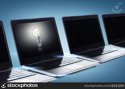 technology and advertisement concept - many laptop computers with blank black screens