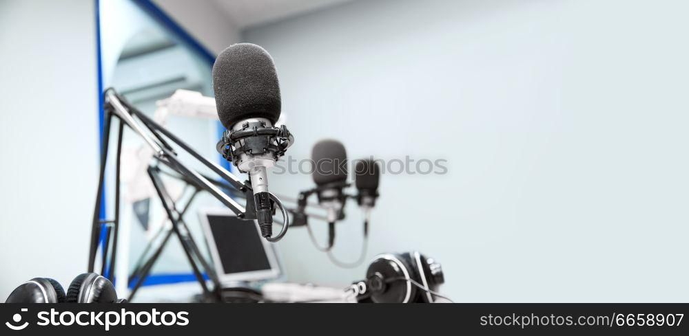 technology and audio equipment concept - microphones at recording studio or radio station. microphones at recording studio or radio station