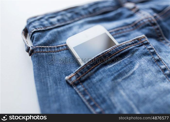 technology and communication concept - smartphone in pocket of denim pants or jeans. smartphone in pocket of denim pants or jeans