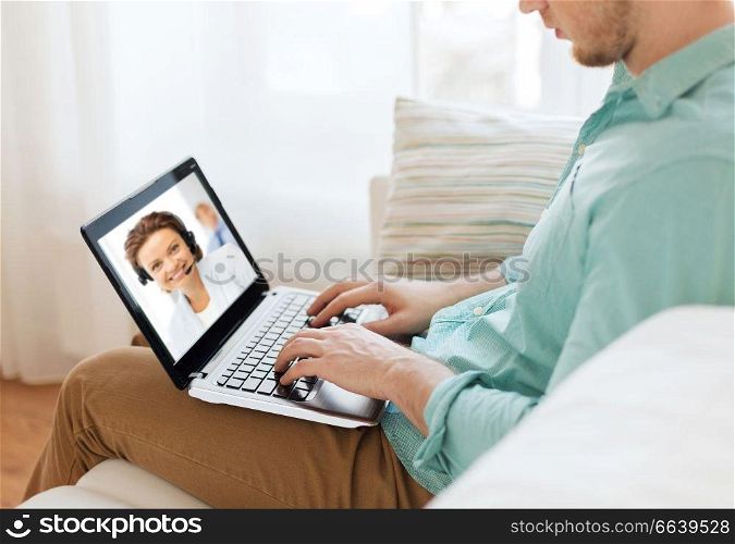 technology and communication concept - woman with laptop computer having video call with customer service operator at home. man having video call with helpline operator