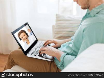 technology and communication concept - woman with laptop computer having video call with customer service operator at home. man having video call with helpline operator